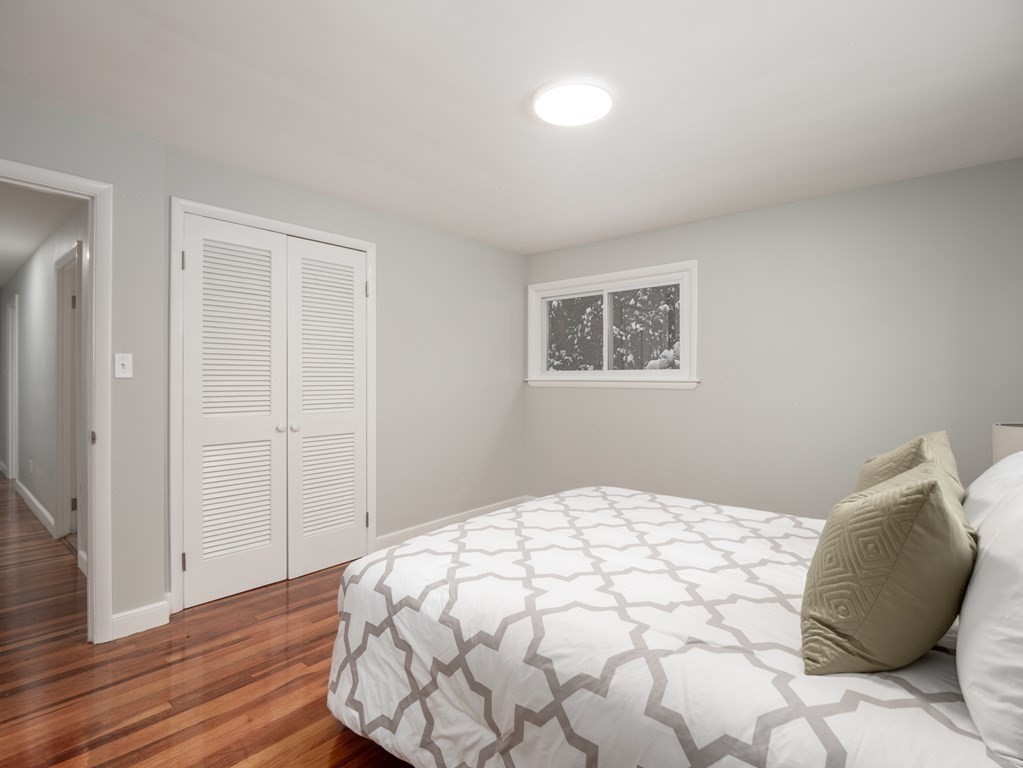 39 Marilyn Road Andover, MA 01810 - Photo 23 of 28 a bedroom with a large bed and wooden floor