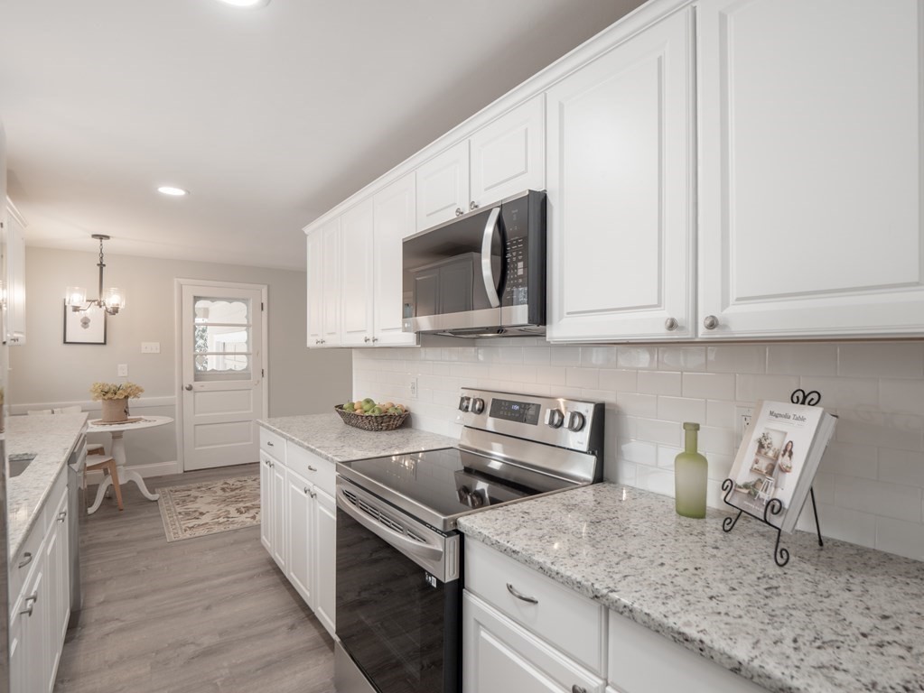 39 Marilyn Road Andover, MA 01810 - Photo 9 of 28 a kitchen with stainless steel appliances granite countertop a sink stove and microwave