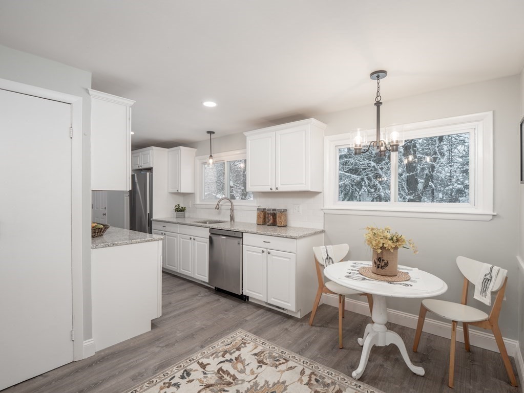 39 Marilyn Road Andover, MA 01810 - Photo 10 of 28 a kitchen with a dining table chairs stove and sink