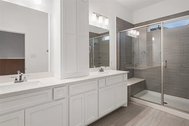 a bathroom with a sink a mirror and a shower