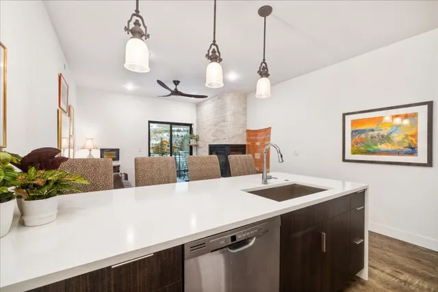 a kitchen with a sink a counter space and wooden floor