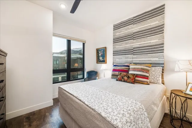 a bedroom with a bed and wooden floor