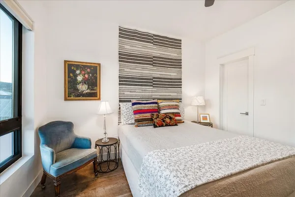 a bedroom with furniture and a wooden floor