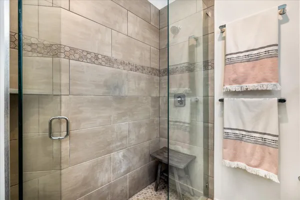 a bathroom with a glass shower door