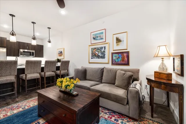 a living room with furniture and wooden floor