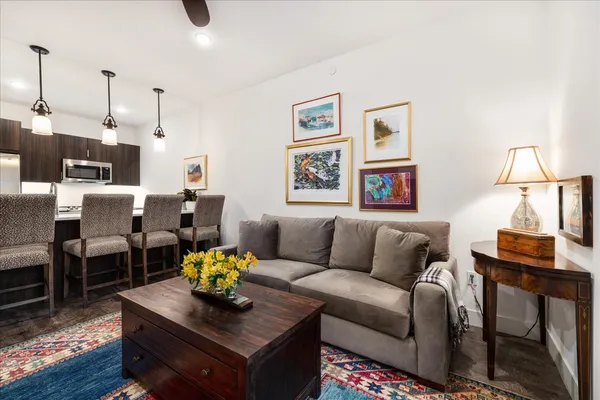 a living room with furniture and wooden floor