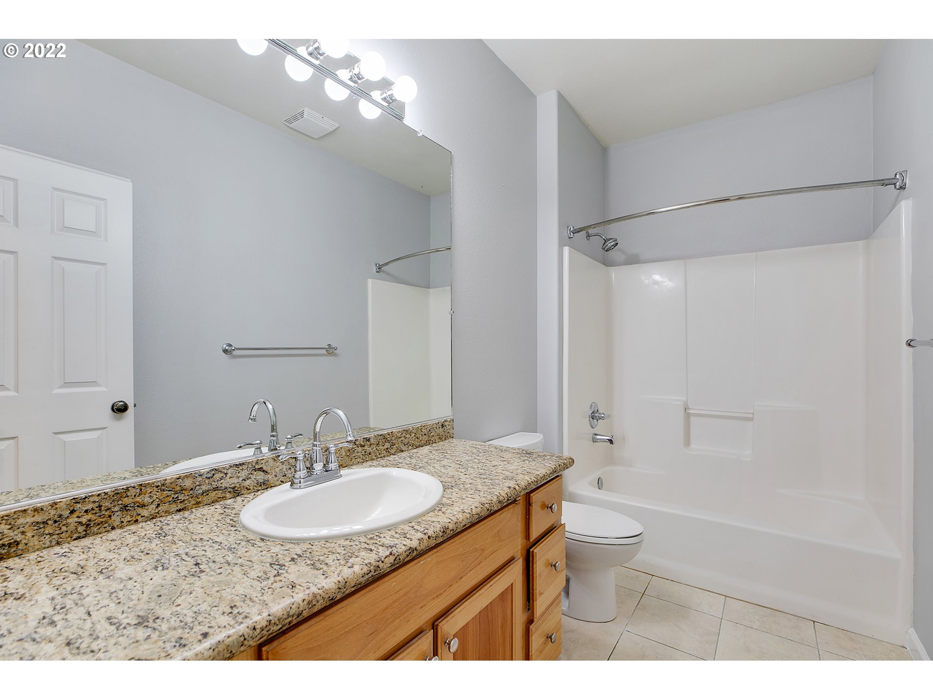 595 Springtree Lane West Linn, OR 97068 - Photo 17 of 28 a bathroom with a granite countertop sink a toilet a mirror and shower