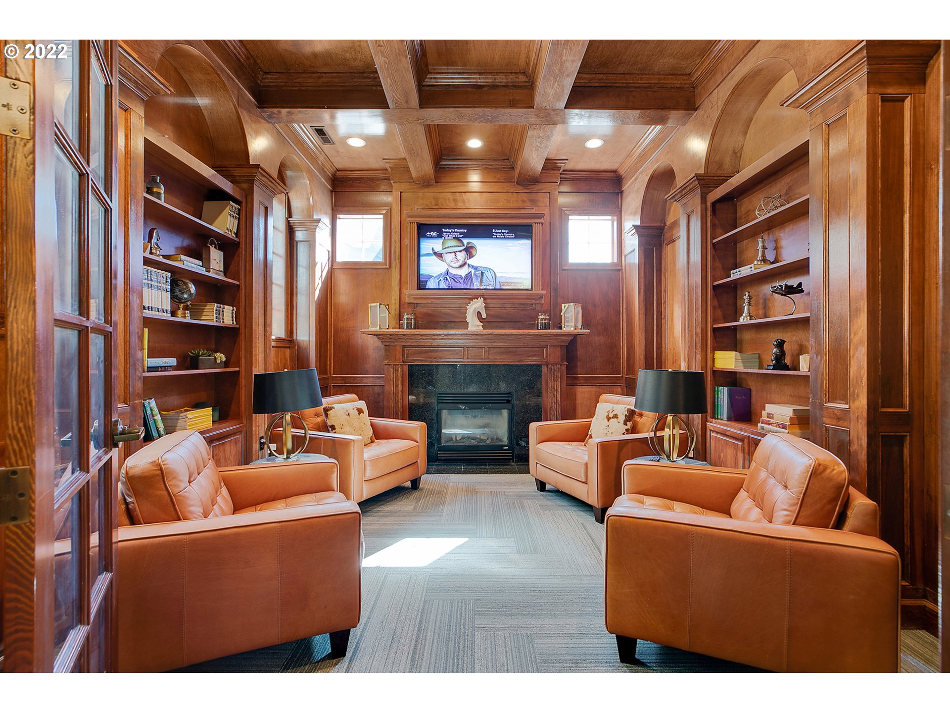 595 Springtree Lane West Linn, OR 97068 - Photo 22 of 28 a living room with furniture a bookshelf and a fireplace