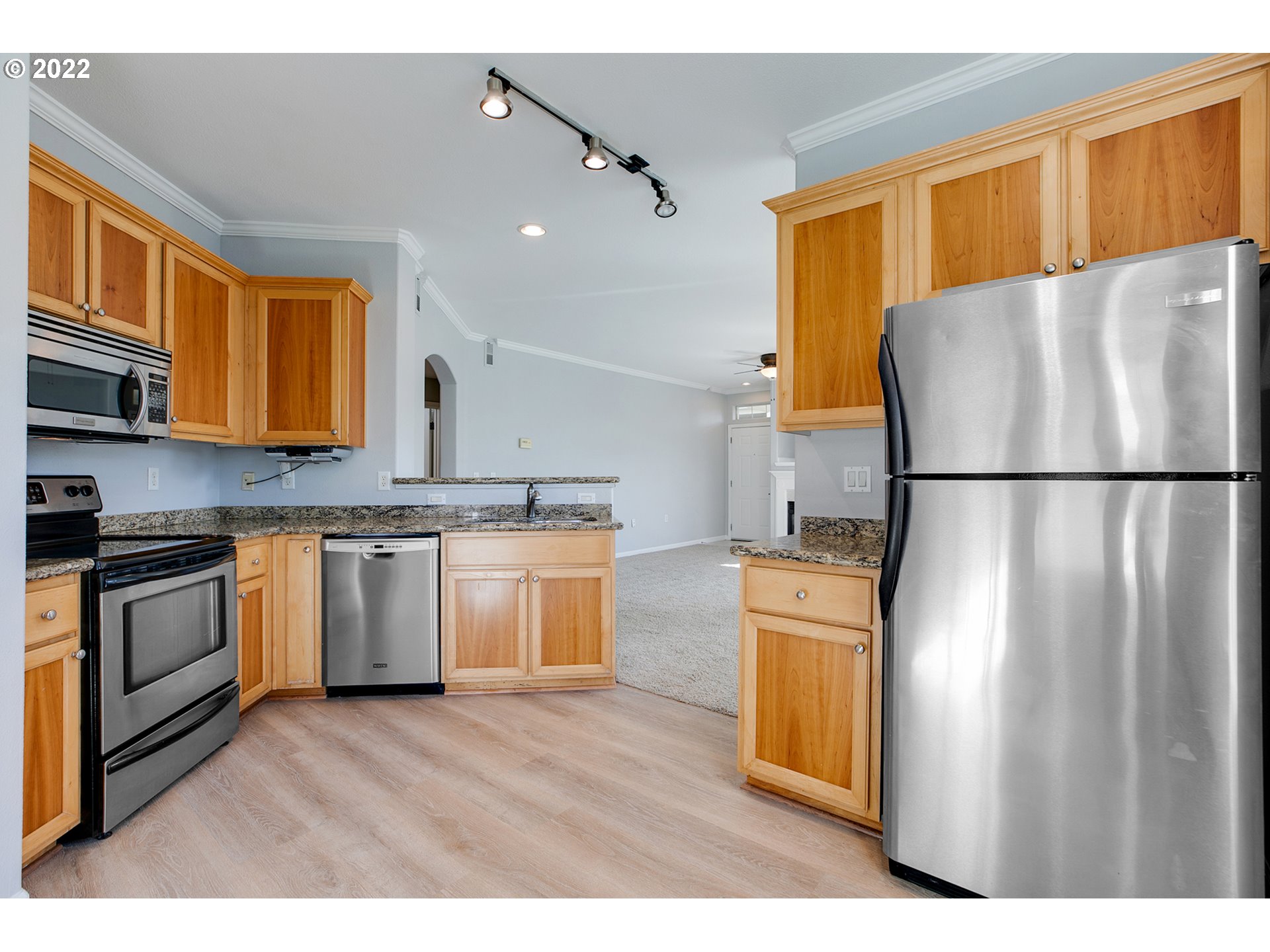 595 Springtree Lane West Linn, OR 97068 - Photo 8 of 28 a kitchen with a refrigerator sink and cabinets