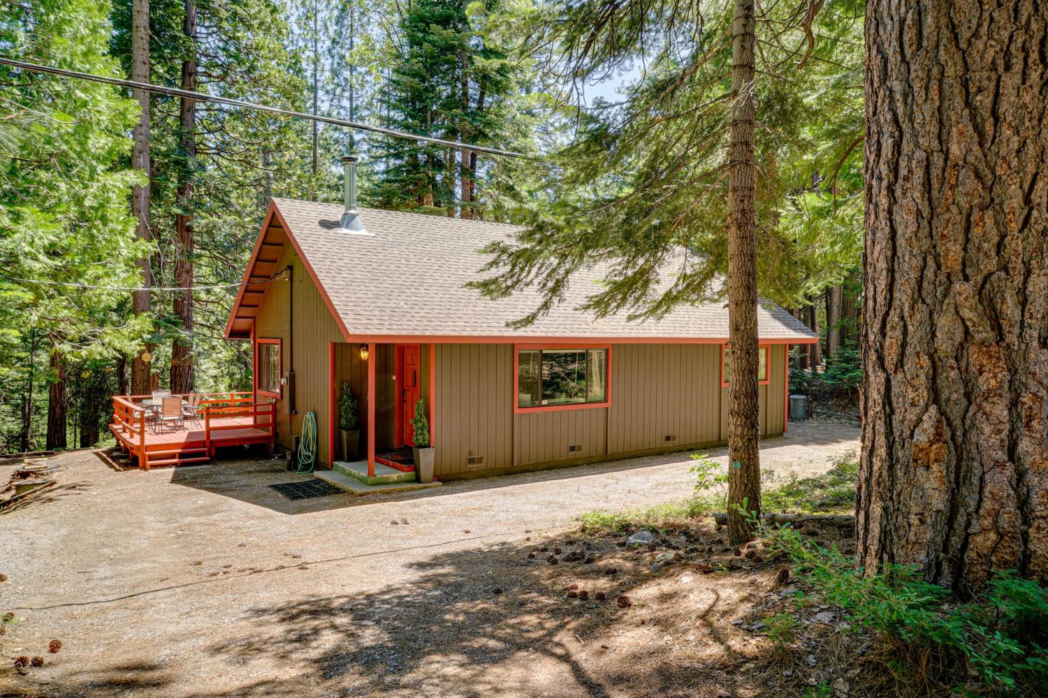 a view of a house with a yard and tree