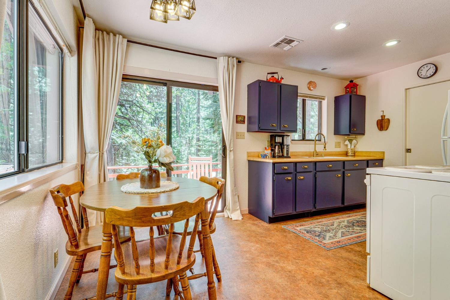 41080 Putt Road Alta, CA 95715 - Photo 15 of 17 a kitchen with stainless steel appliances kitchen island granite countertop a table chairs sink and cabinets