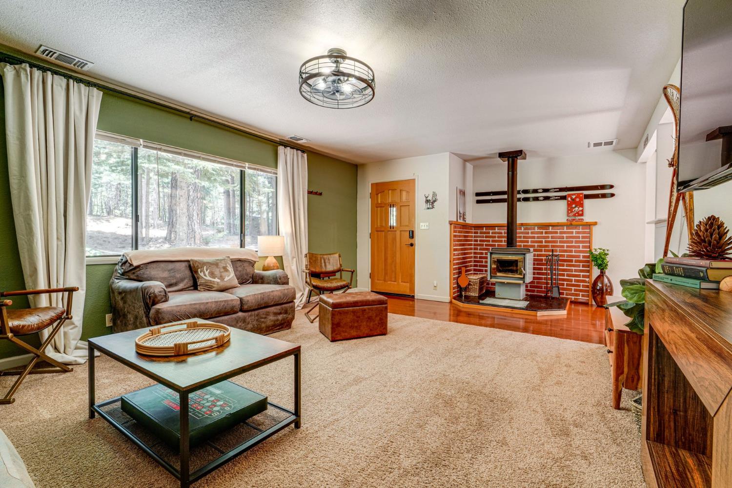 41080 Putt Road Alta, CA 95715 - Photo 4 of 17 a living room with furniture a flat screen tv and a large window