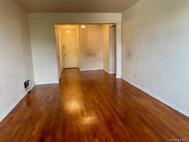 48-21 40th Street, Unit 2C Queens, NY 11104 - Photo 3 of 7 a view of an empty room with wooden floor and a window