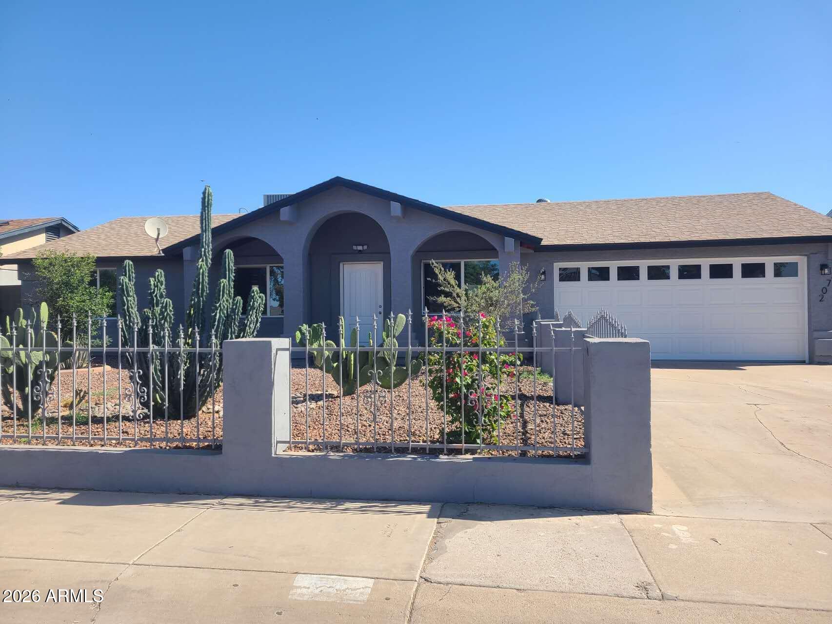 3702 East Thunderbird Road Phoenix, AZ 85032 - Photo 1 of 23 a front view of a house with garden