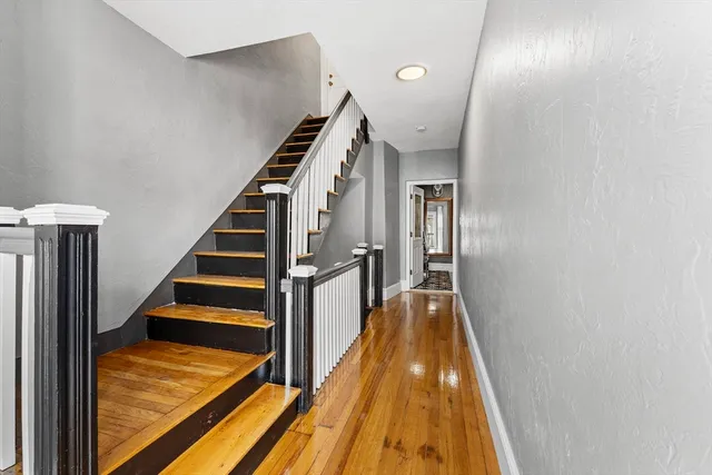 a view of entryway and hall with wooden floor