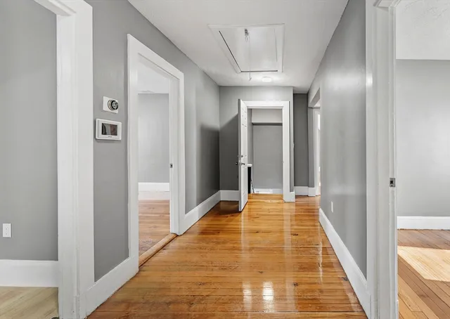a view of hallway with wooden floor
