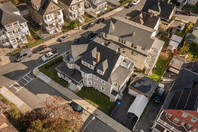 an aerial view of a house with a yard