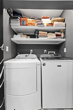a view of a bedroom with wooden floor and window