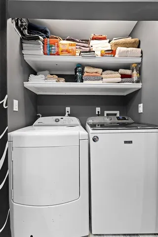a view of a bedroom with wooden floor and window
