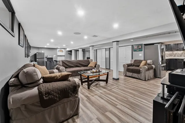 a living room with furniture kitchen view and a table