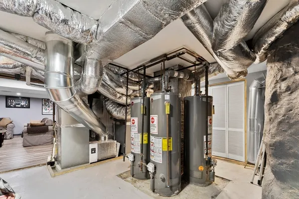 a view of a hallway with wooden floor and a living room