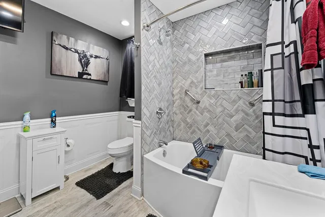 a bathroom with a sink a toilet and shower