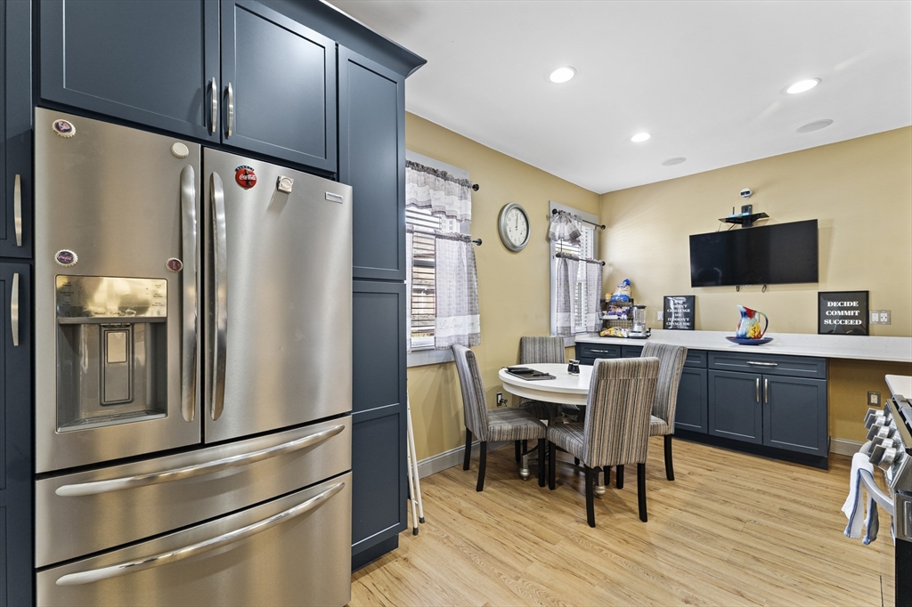 69 Greenwood Street Boston, MA 02121 - Photo 10 of 42 a kitchen with stainless steel appliances a refrigerator and a stove top oven