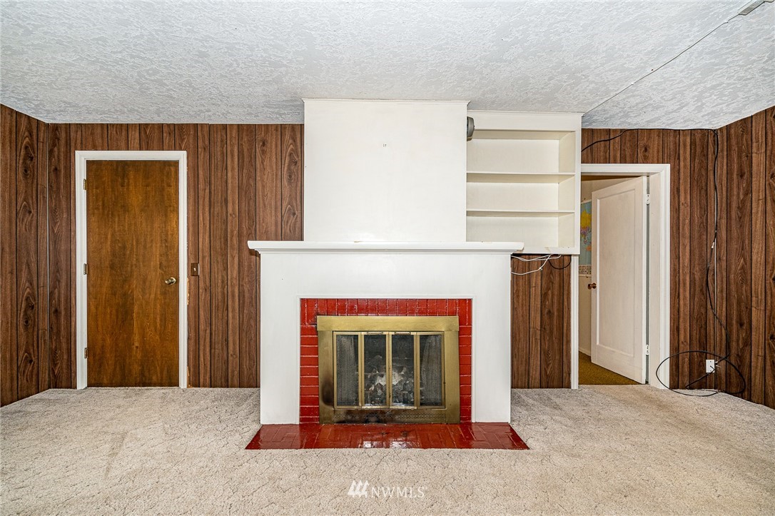 1458 Rush Road Chehalis, WA 98532 - Photo 7 of 40 an empty room with a fireplace and window