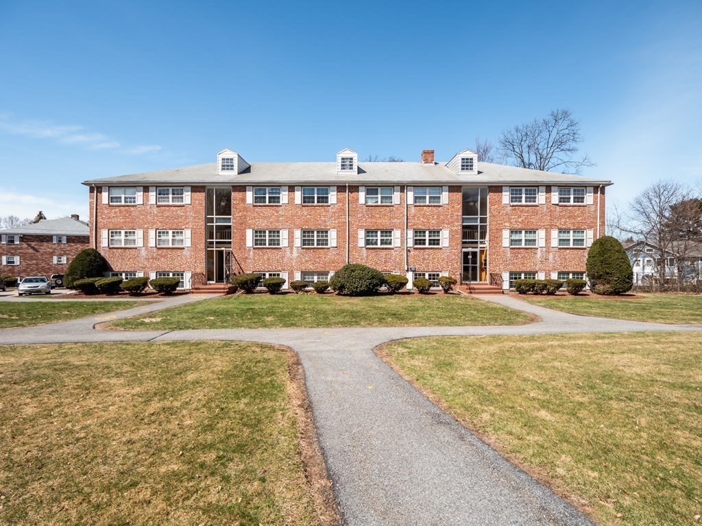 67 Fernview Avenue, Unit 2 North Andover, MA 01845 - Photo 1 of 8 a large building with a swimming pool in front of it