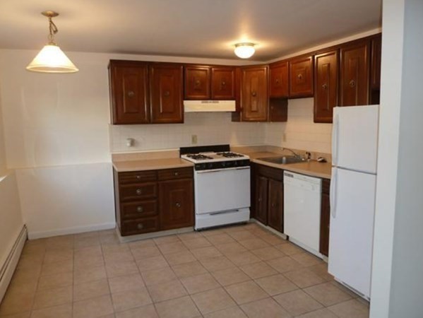 67 Fernview Avenue, Unit 2 North Andover, MA 01845 - Photo 3 of 8 a kitchen with a sink a stove and cabinets