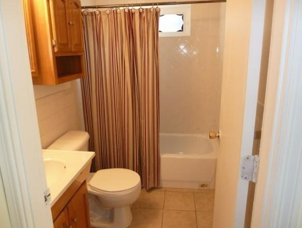 67 Fernview Avenue, Unit 2 North Andover, MA 01845 - Photo 7 of 8 a bathroom with a toilet and a shower curtain