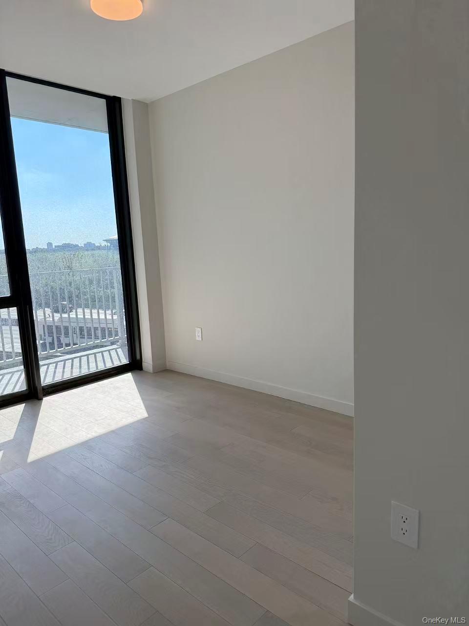 131-02 40th Road, Unit 6G Queens, NY 11354 - Photo 11 of 11 a view of an empty room with a window