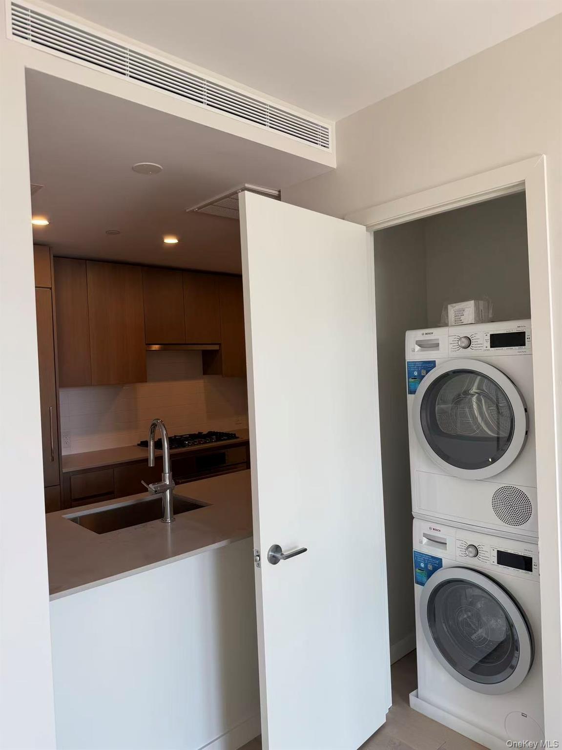 131-02 40th Road, Unit 6G Queens, NY 11354 - Photo 4 of 11 a view of a storage & utility room with washing machine