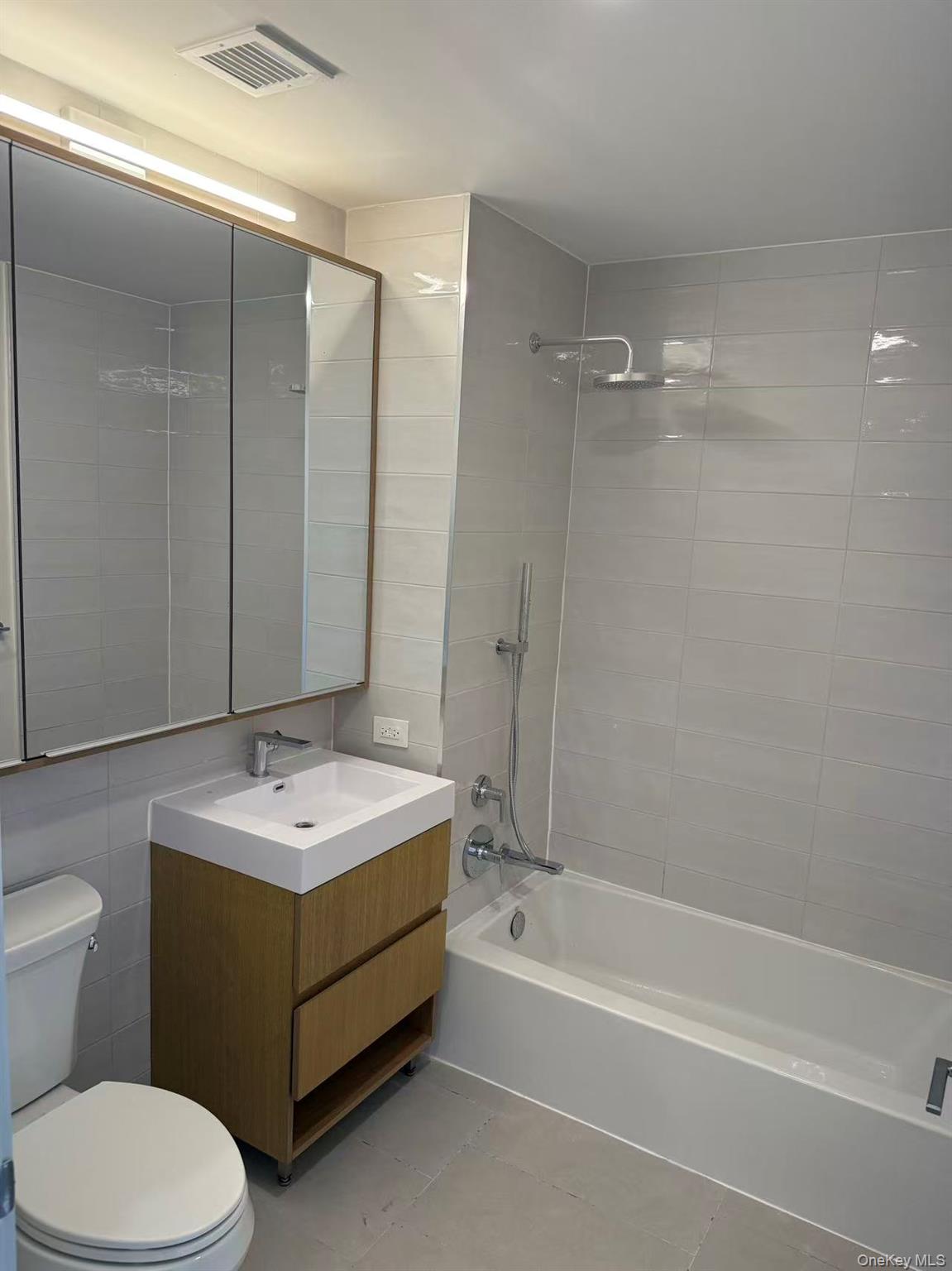 131-02 40th Road, Unit 6G Queens, NY 11354 - Photo 7 of 11 a bathroom with a sink toilet and shower