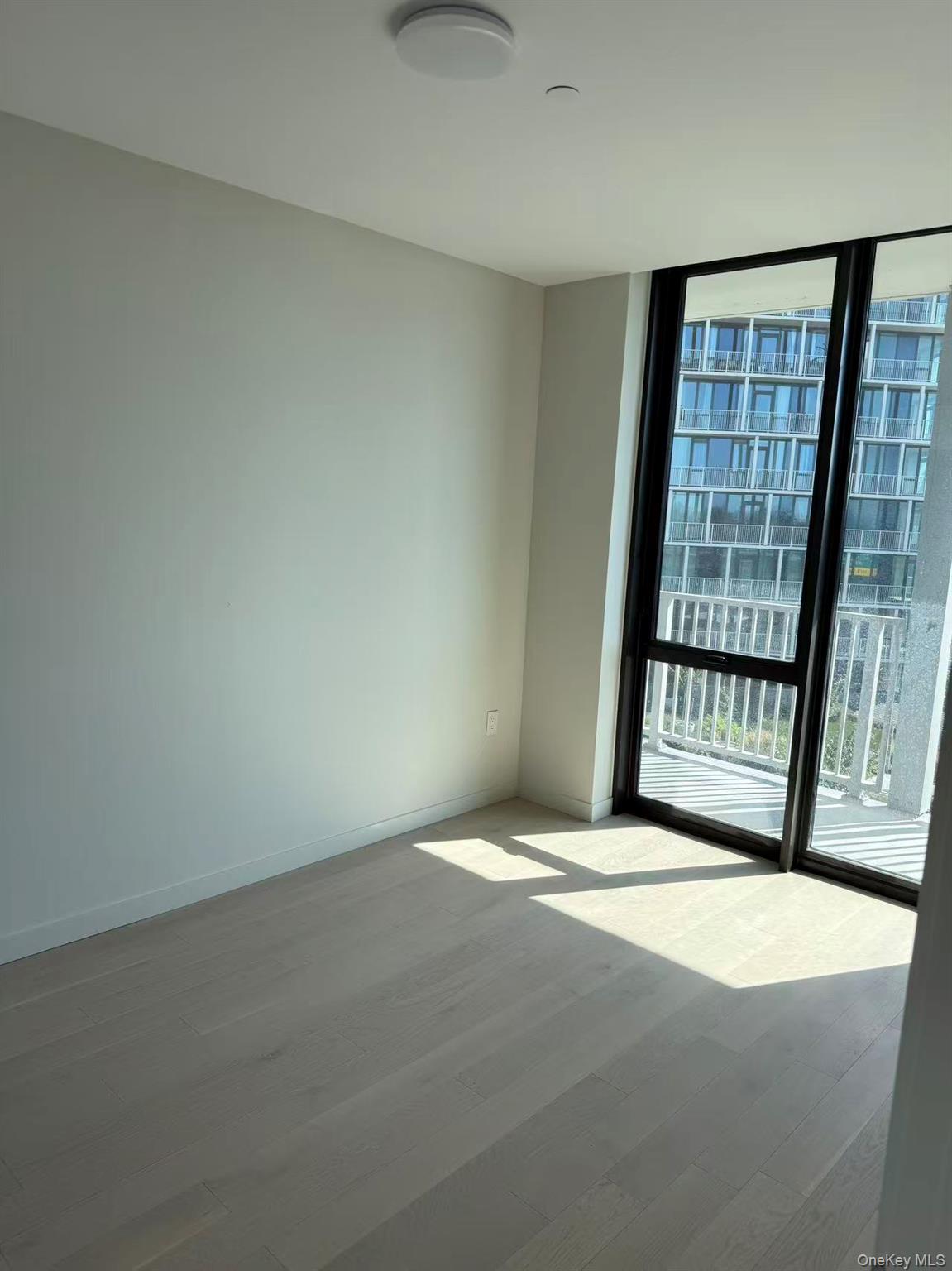 131-02 40th Road, Unit 6G Queens, NY 11354 - Photo 10 of 11 an empty room with windows