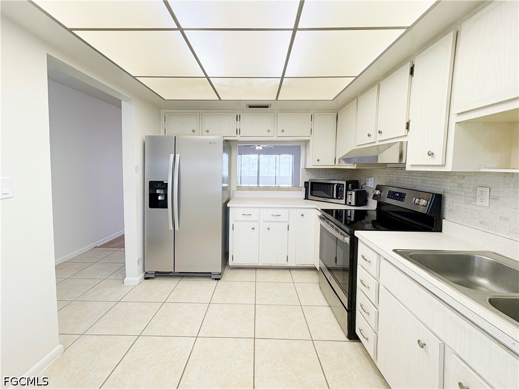 1830 Brantley Road, Unit I7 Fort Myers, FL 33907 - Photo 8 of 34 a kitchen with a sink a refrigerator and cabinets