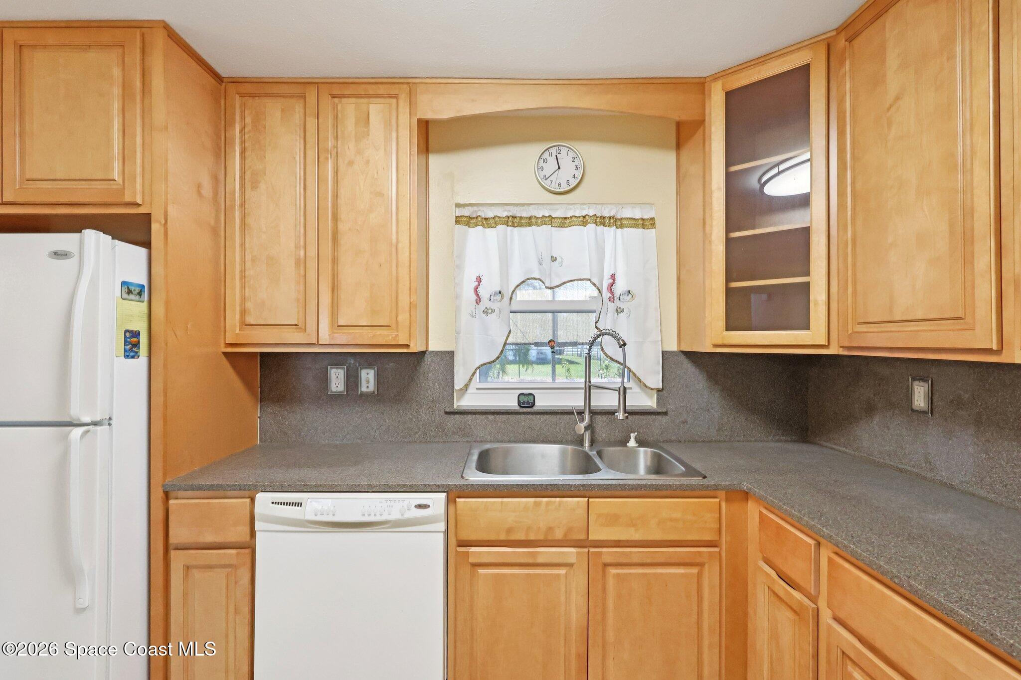 1945 Madison Avenue Melbourne, FL 32935 - Photo 13 of 33 a kitchen with stainless steel appliances granite countertop a sink and a refrigerator