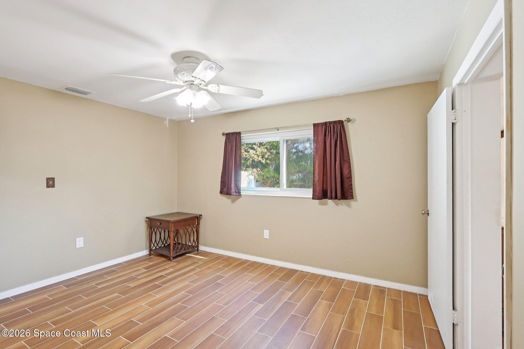 1945 Madison Avenue Melbourne, FL 32935 - Photo 20 of 33 a view of an empty room with window and wooden floor