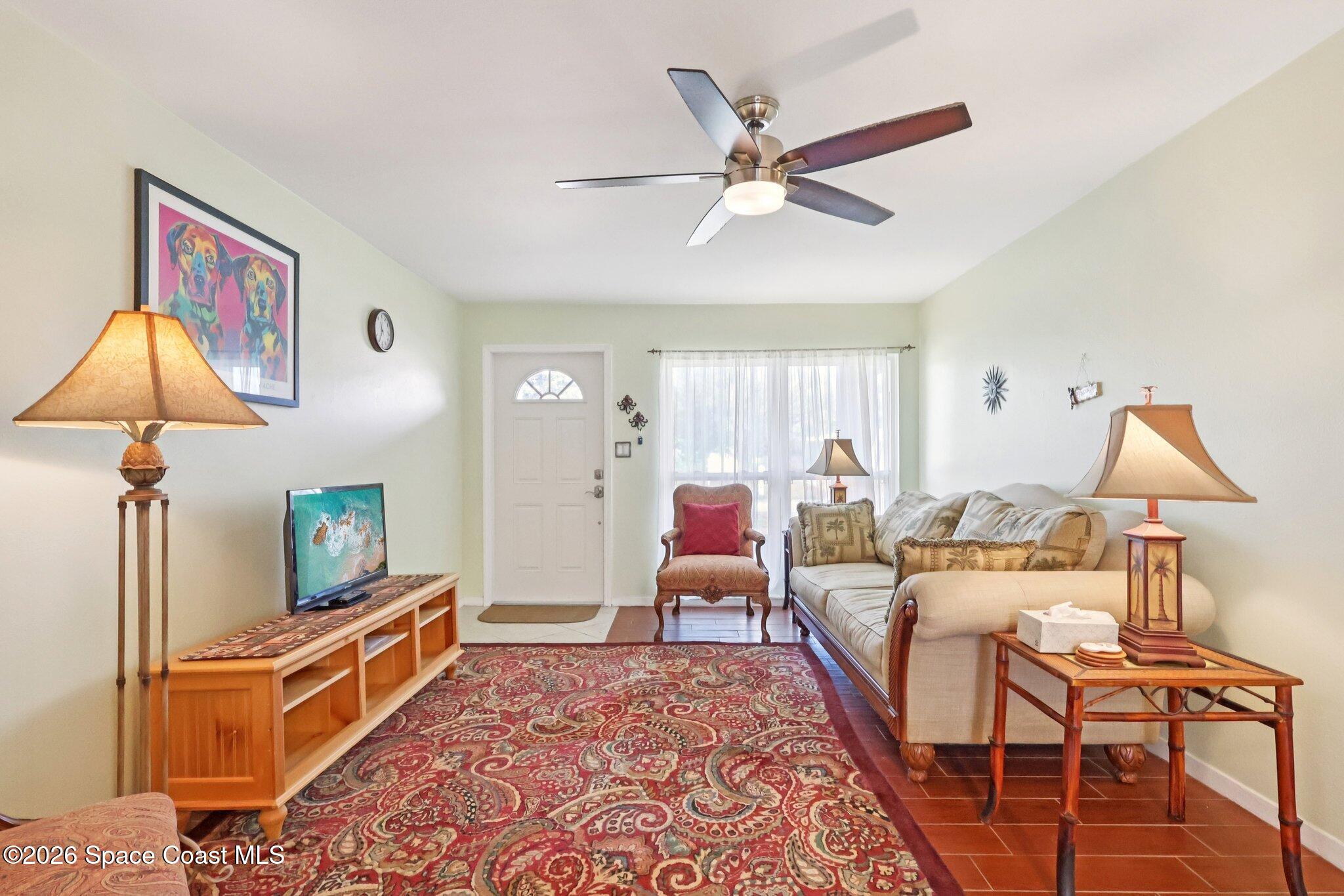 1945 Madison Avenue Melbourne, FL 32935 - Photo 2 of 33 a living room with furniture and a flat screen tv