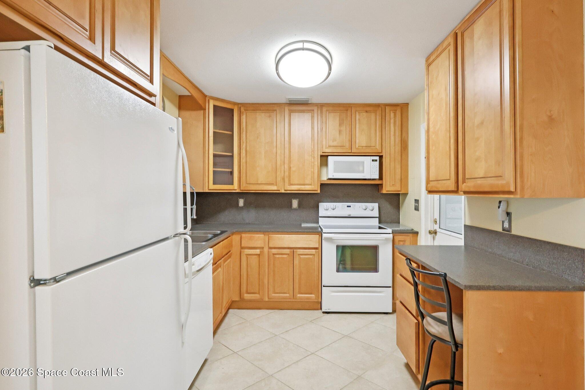 1945 Madison Avenue Melbourne, FL 32935 - Photo 3 of 33 a kitchen with stainless steel appliances granite countertop a refrigerator sink and stove