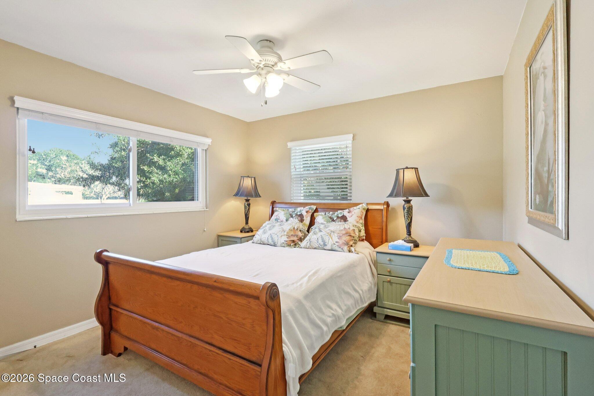1945 Madison Avenue Melbourne, FL 32935 - Photo 6 of 33 a bedroom with a bed and a chandelier