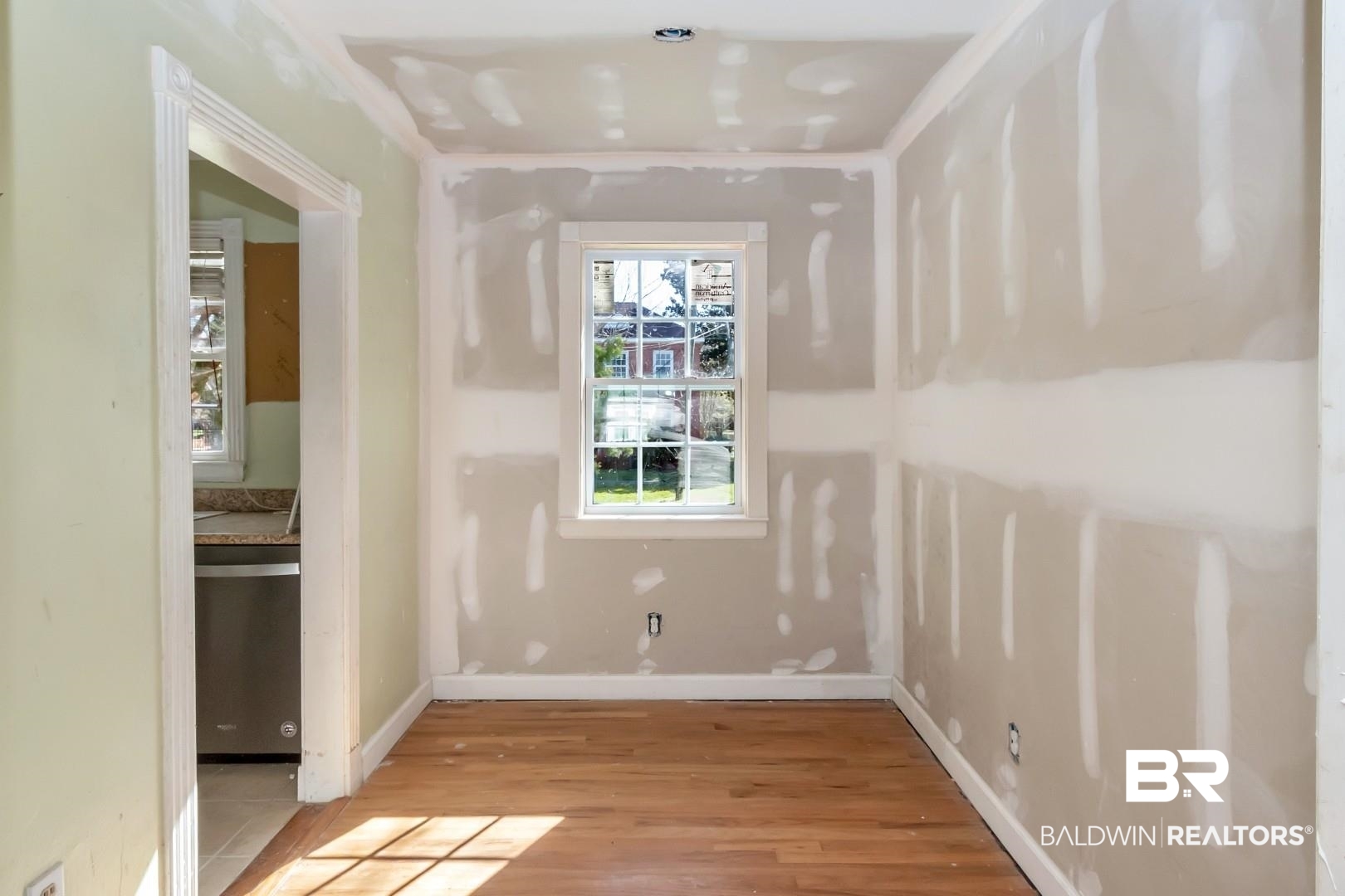 214 Upham Street, Unit 4A Mobile, AL 36607 - Photo 16 of 23 Empty room with light wood-style flooring and baseboards
