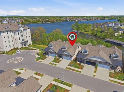 an aerial view of a house with outdoor space lake view and mountain view in back