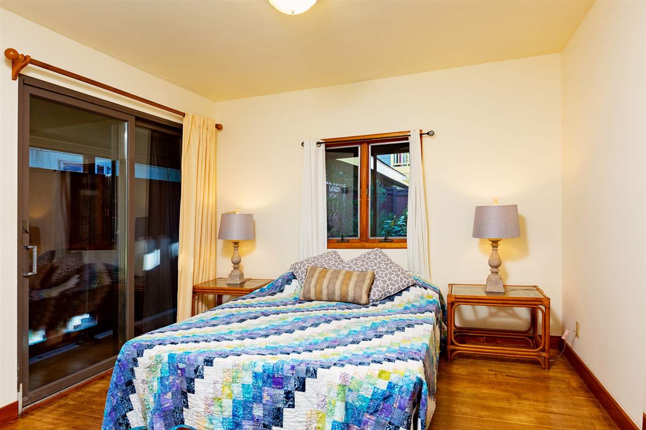 718 Holopuni Road Kula, HI 96790 - Photo 12 of 21 a bedroom with a bed and a lamp with the dresser