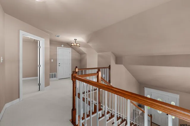 an empty room with windows and ceiling fan