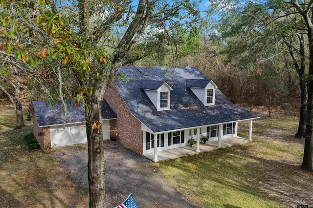 a aerial view of a house next to a yard