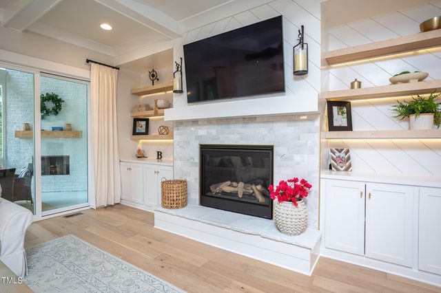 a living room with a flat screen tv and a fireplace