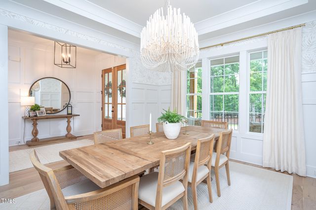 a dining room with furniture a window and chandelier