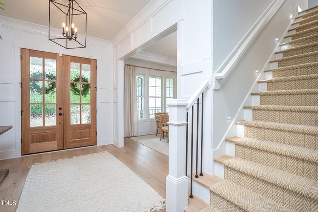 a view of entryway and hall with wooden floor