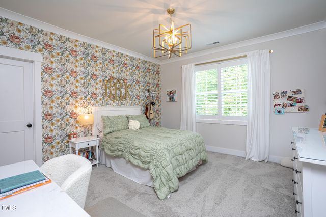 a spacious bedroom with a bed and a window